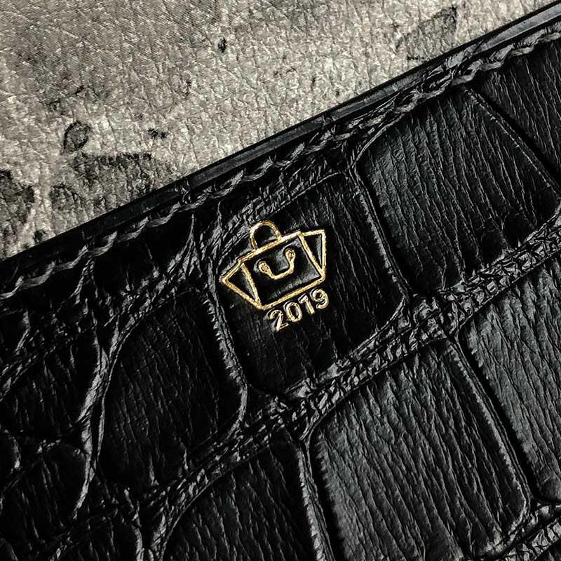 The peter nitz logo etched onto the tether pouch in croc