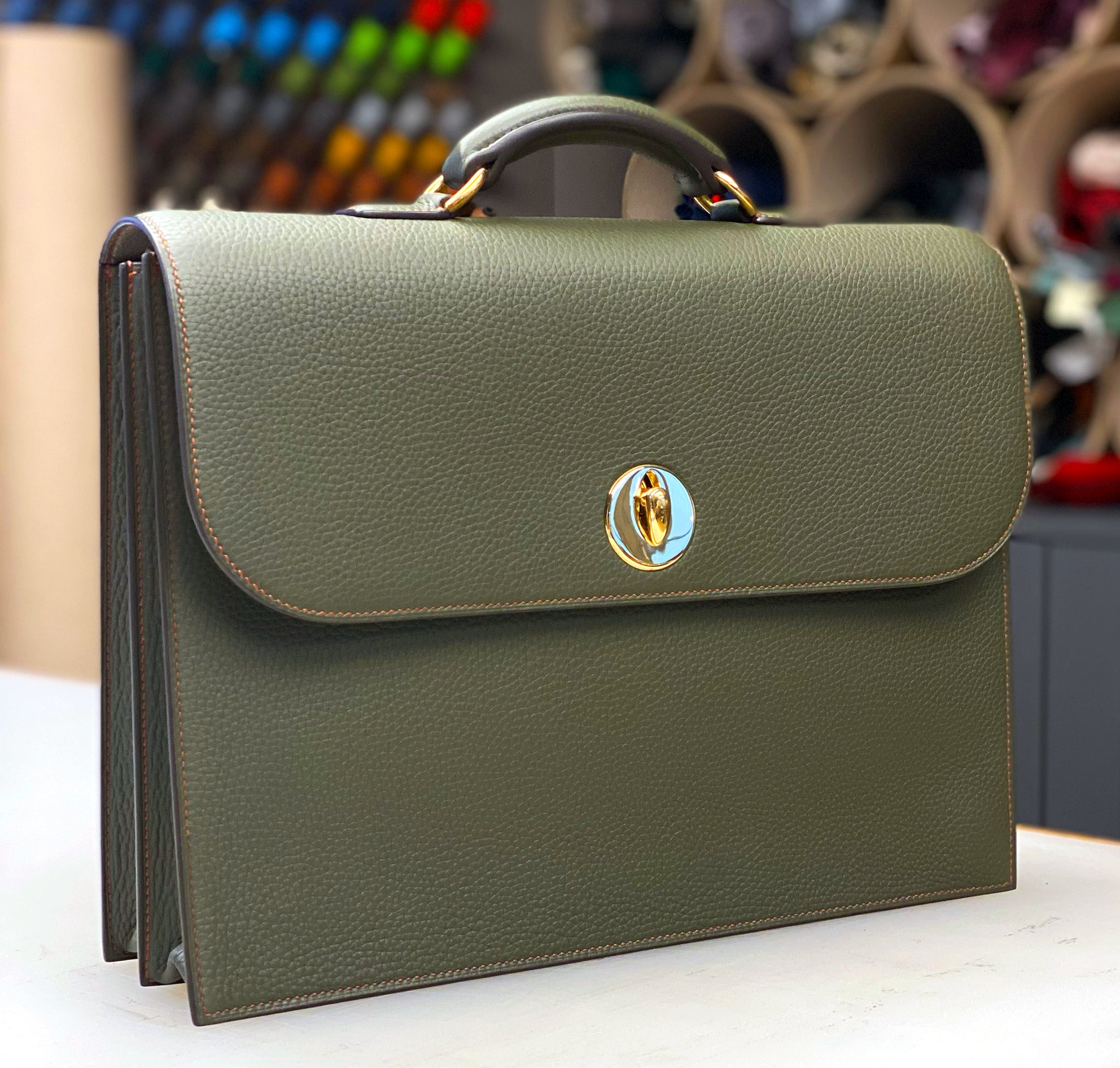 Olive green leather hackney briefcase with gold hardware closure